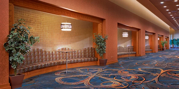 Hotel lobby with tables and chairs.