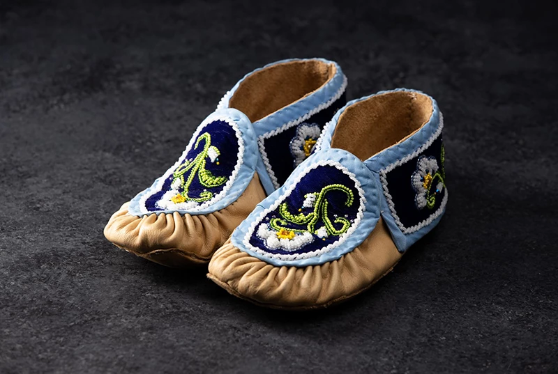 Designed Moccasin with a blue background and a white flower